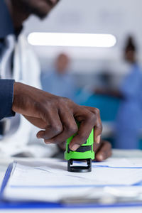 Midsection of man using mobile phone