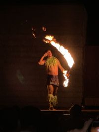 Midsection of woman with fire crackers at night