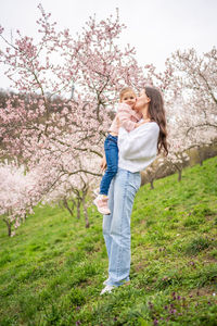 Side view of woman standing on grassy field