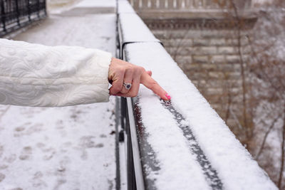 Close-up of hand holding snow