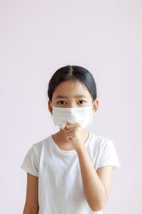 Portrait of boy standing against white background