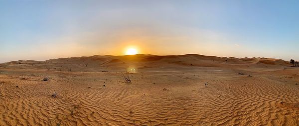 Scenic view of desert against sky during sunset