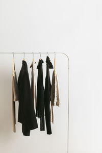 Modern rack with capsule collection in neutral black and beige colours. 