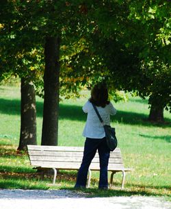 Rear view of woman standing on grass