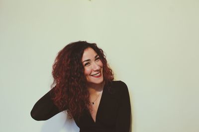 Portrait of a smiling young woman against white background