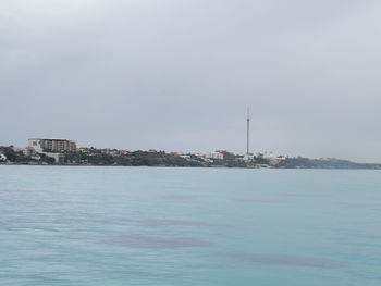 Scenic view of sea and buildings against sky