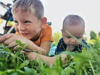 Close-up of cute boy holding plant