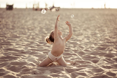 Full length of toddler girl at beach