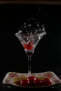 Close-up of drink on table against black background