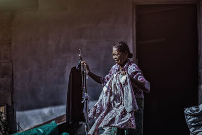 Senior woman holding clothes