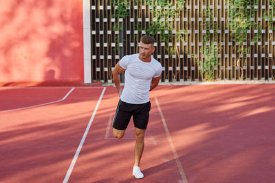 Full length of man playing tennis