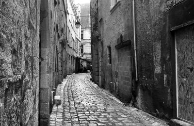 Cobblestone street amidst buildings