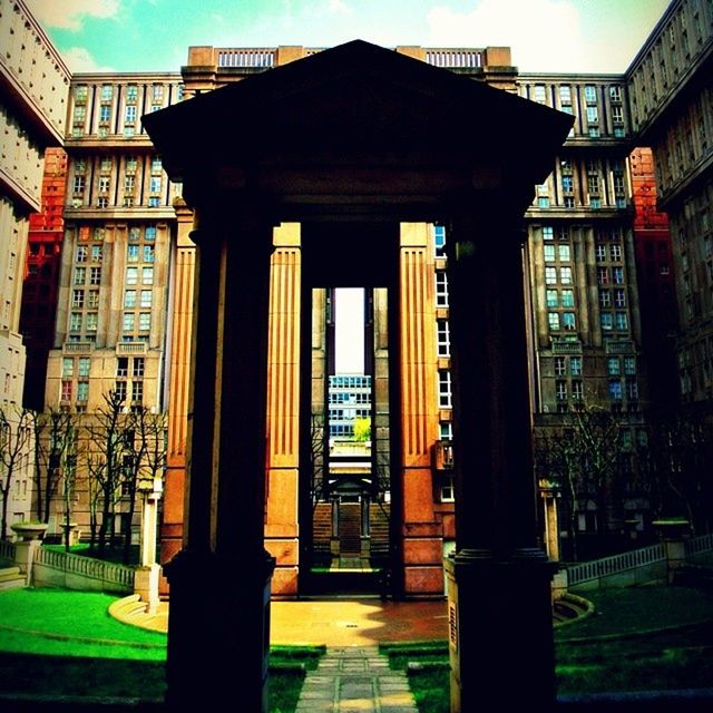 architecture, built structure, building exterior, architectural column, city, sunlight, building, window, sky, column, shadow, day, residential building, residential structure, no people, outdoors, travel destinations, blue, exterior, facade