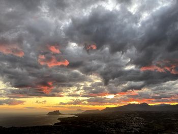 Scenic view of dramatic sky over landscape during sunset