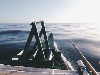 Boat sailing in sea against clear sky