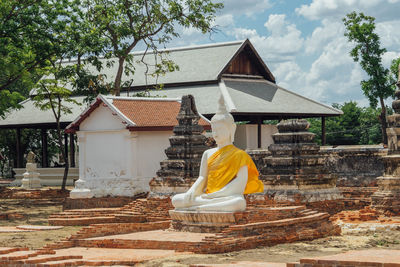 View of buddha statue against building