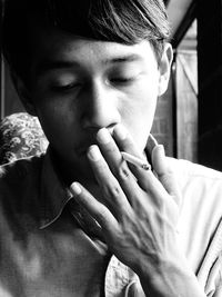 Close-up of man smoking cigarettes