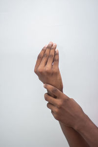 Close-up of person hand against white background