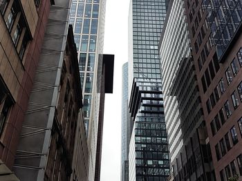 Low angle view of buildings in city against clear sky