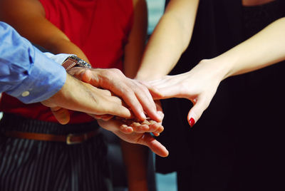 Midsection of couple holding hands