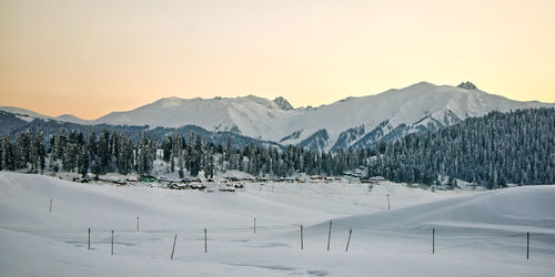 Scenic view of snow covered mountains against sky