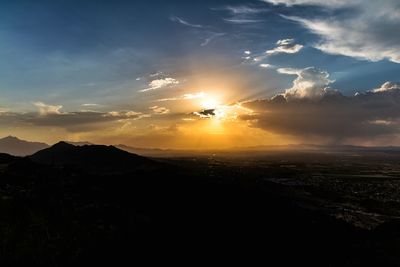 Silhouette of mountain against sky at sunset