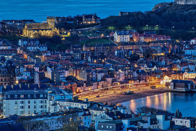 High angle view of illuminated buildings at waterfront in scarborough