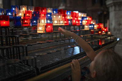 Cropped hand of man holding illuminated lights