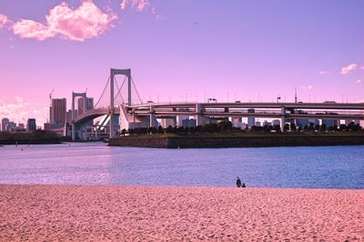 Scenic view of bridge over sea against cloudy sky