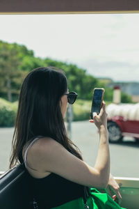 One young girl with a phone in her hands.