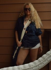 Portrait of beautiful young woman wearing sunglasses standing outdoors