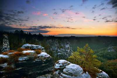 Scenic view of rocks against sky during sunset