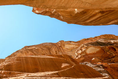 Scenic view of desert against clear blue sky