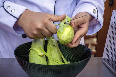 Midsection of man holding fruit