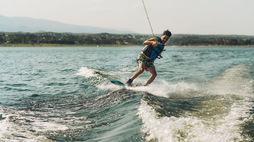 Full length of man doing wakeboard in a lake