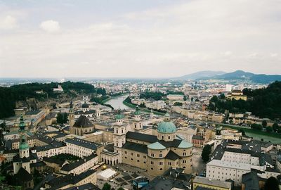 Cityscape against cloudy sky