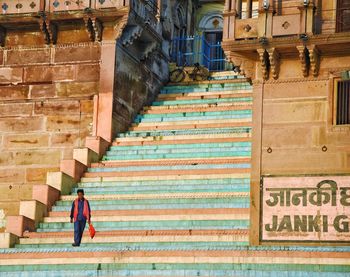 Low section of woman walking on staircase