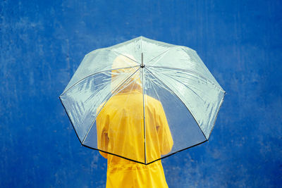 Low angle view of umbrella against blue sky