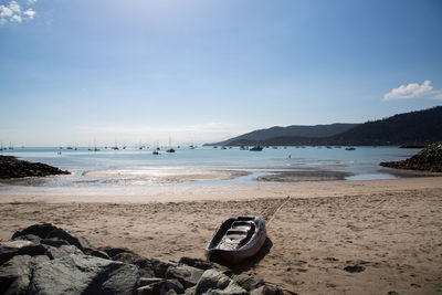 Nautical vessel on beach against sky