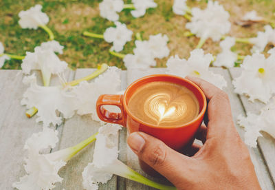 Midsection of person holding coffee cup