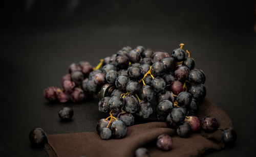 Close-up of fruits on table against black background