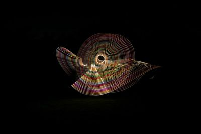 Illuminated light painting against black background