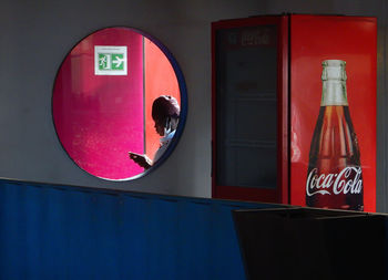 Reflection of red mirror on glass wall