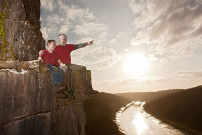 Father and son sitting on a ledge