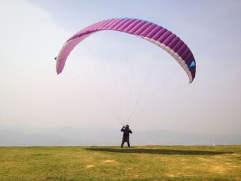 Hot air balloon flying over field