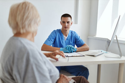 Side view of doctor working at office