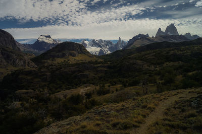 Scenic view of mountains against cloudy sky