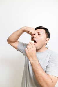 Midsection of man standing against white background