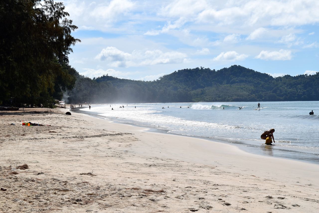 beach, sand, water, sky, sea, shore, mountain, scenics, tranquil scene, beauty in nature, tranquility, nature, vacations, leisure activity, incidental people, lifestyles, cloud - sky, coastline, tree