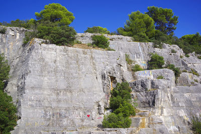 Low angle view of stone wall on rock